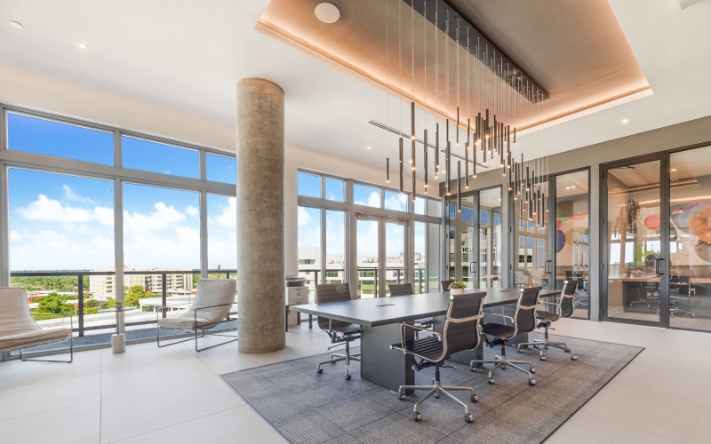 Resident coworking space with communal seating and private work rooms